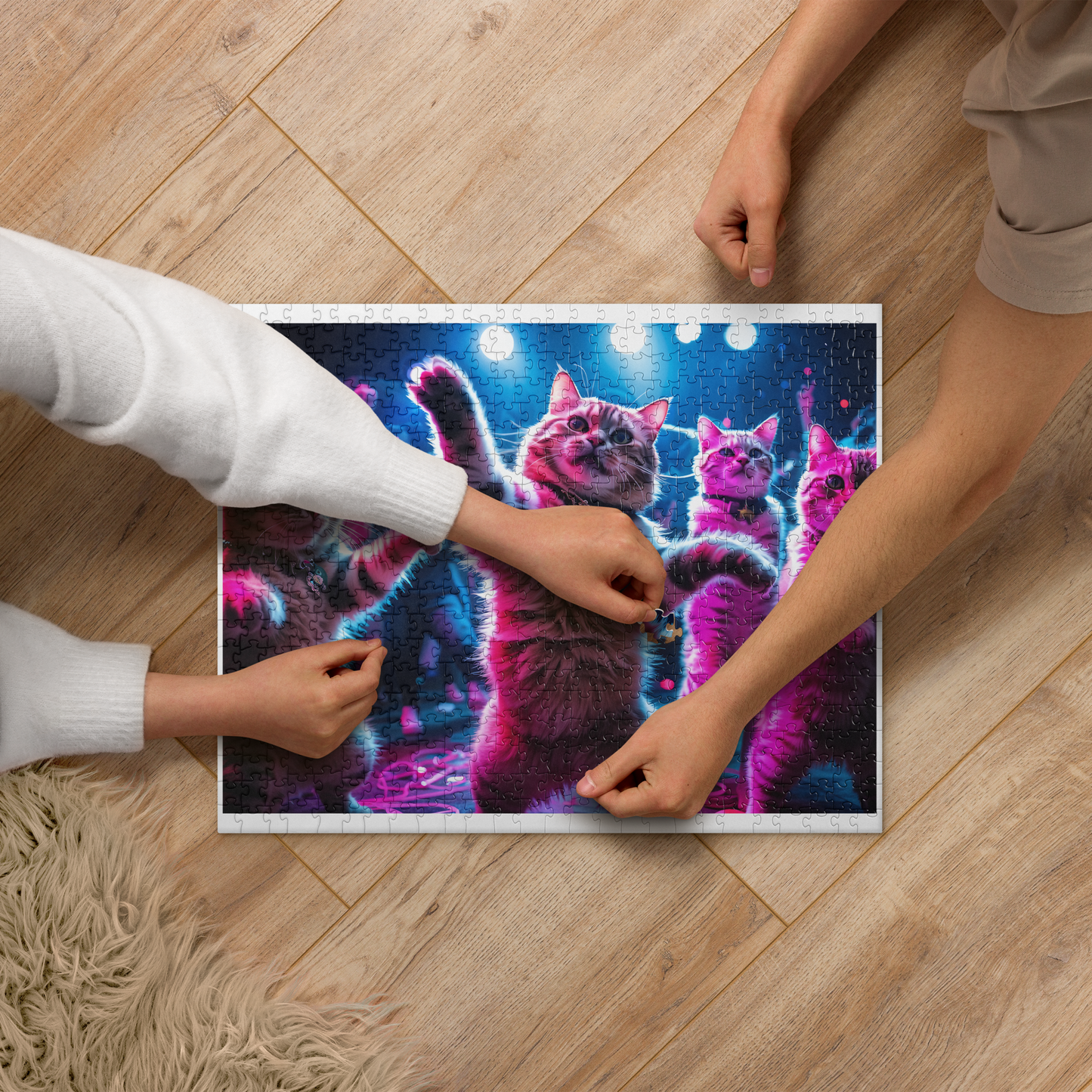 Two people working on a puzzle of cats with colorful lights on a wooden floor.
