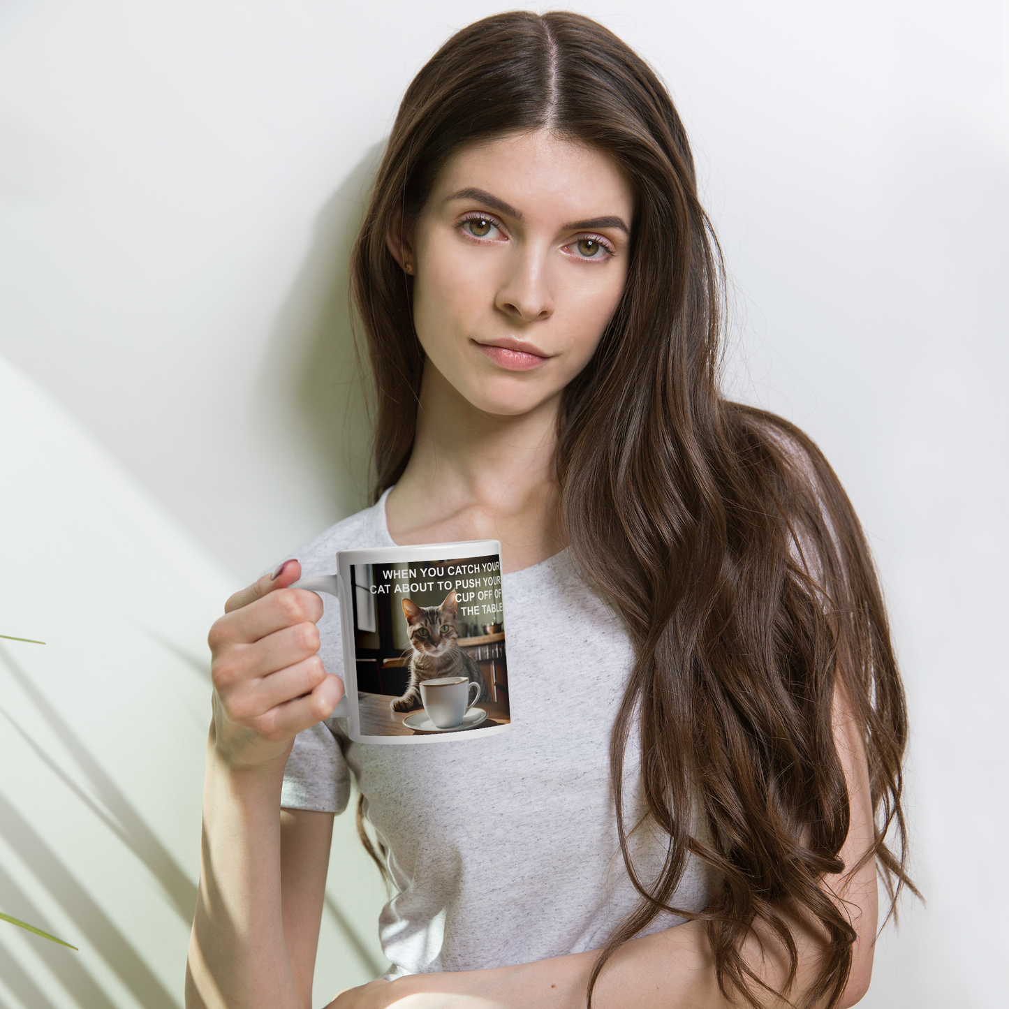 Woman holding a mug with a printed design on a light background - 20 oz