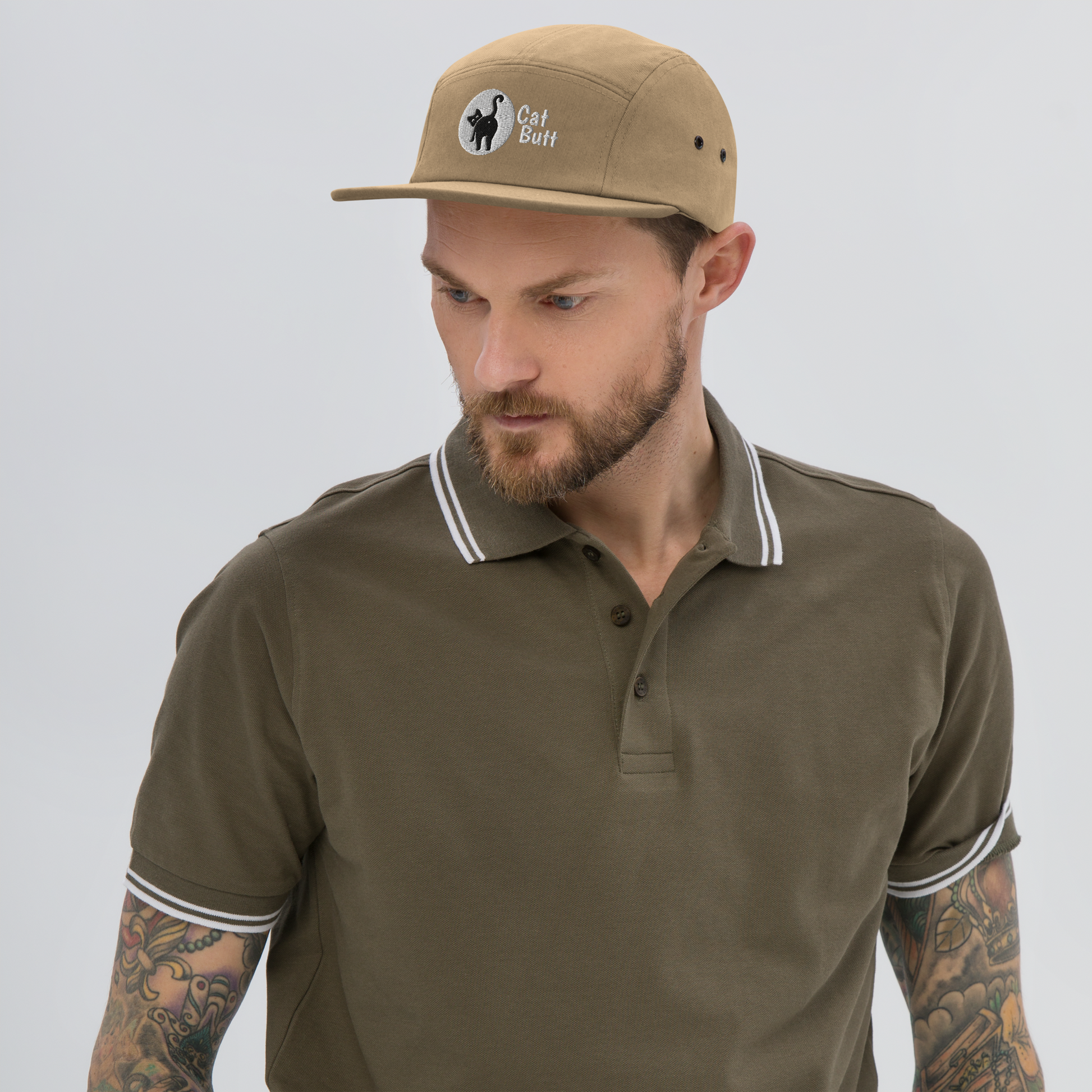 Man wearing a brown cap and matching polo shirt on a light gray background - khaki