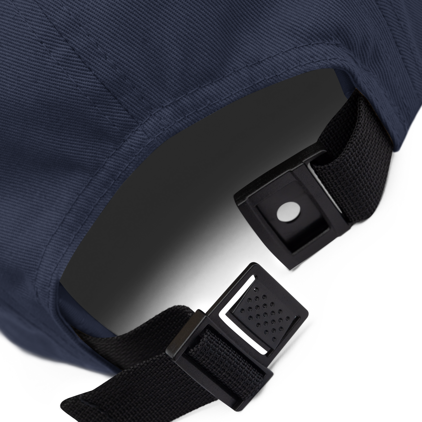 Close-up of a navy blue jacket with black straps and buckles on a white background - navy