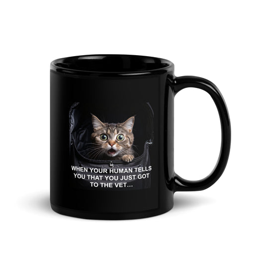 A black glossy mug with a cat meme about going to the vet. The handle is to the right - 11 oz