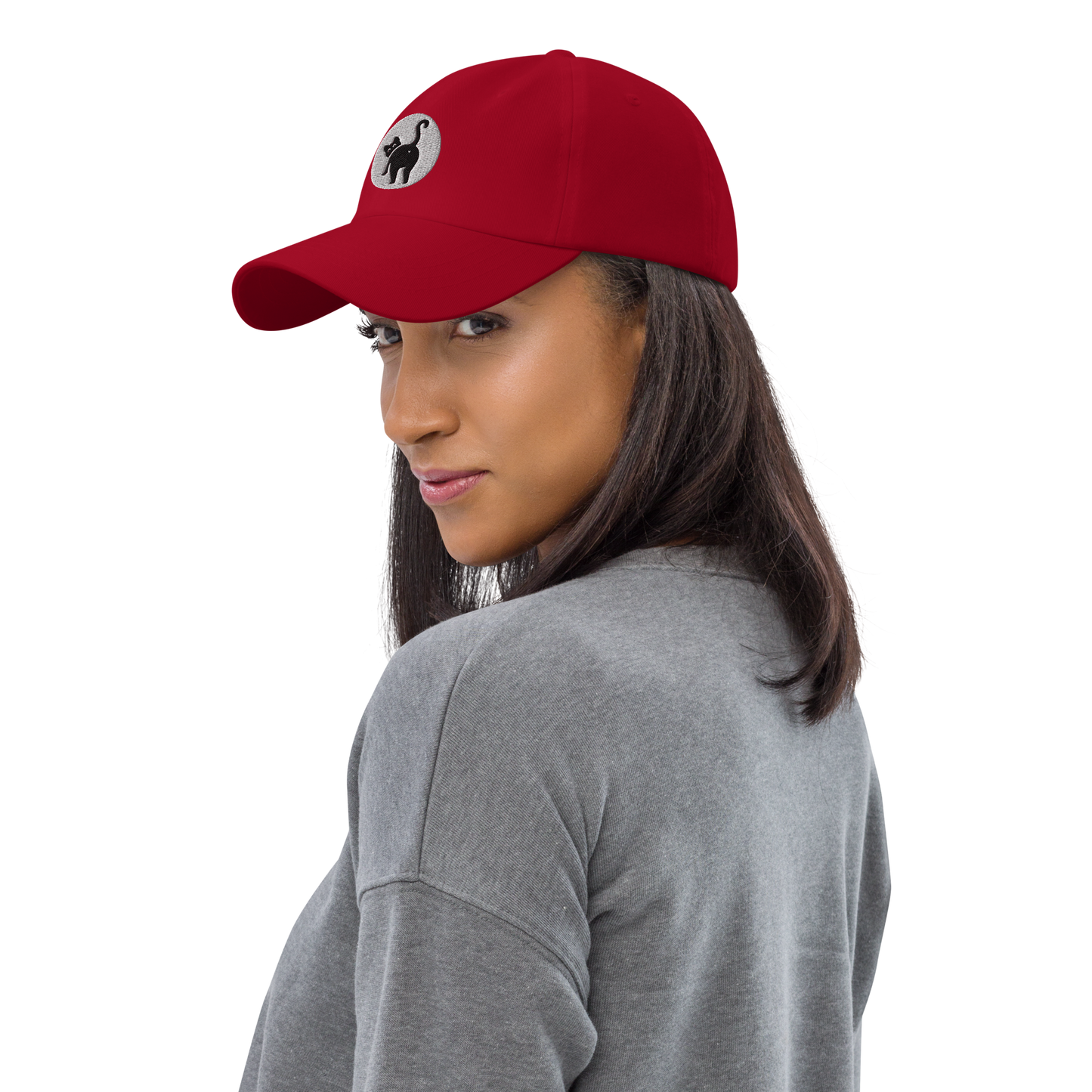 Woman wearing a red cap with a logo on a white background - cranberry