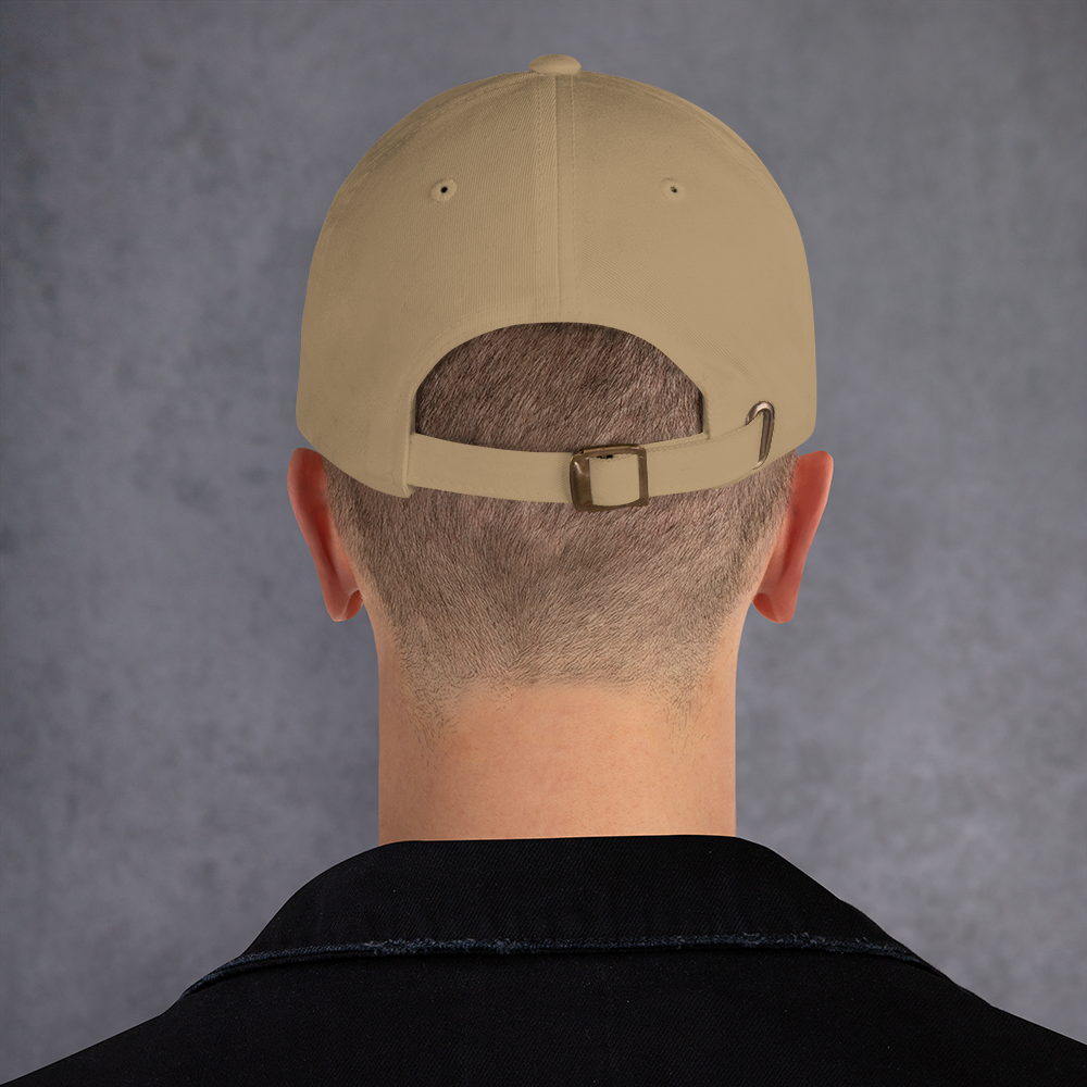 Beige cap worn backwards on a person with a gray background - khaki