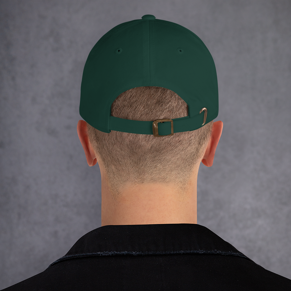 Person wearing a green cap with a brown buckle on a gray background - spruce