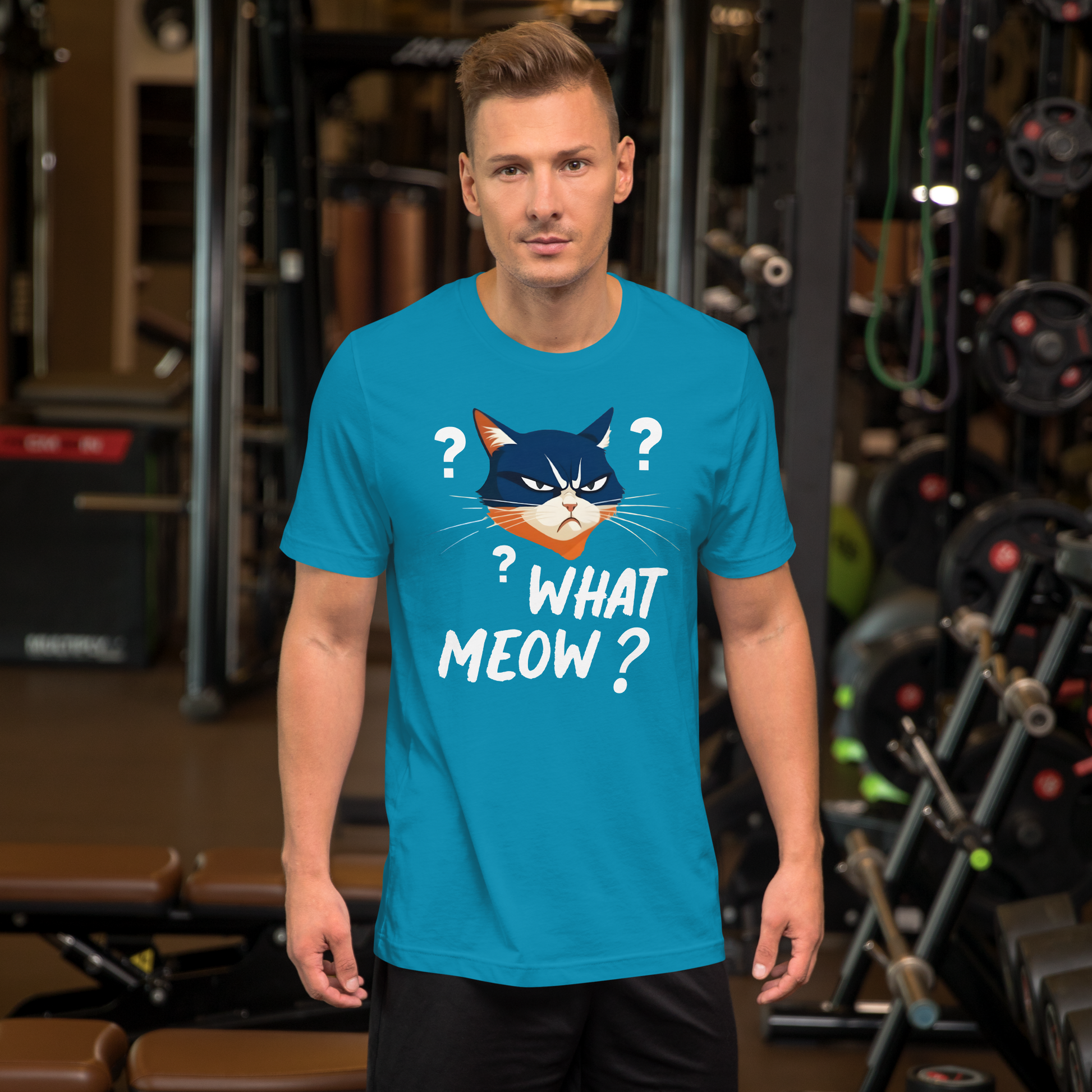 Man wearing a blue t-shirt with a cat graphic and text in a gym setting - aqua