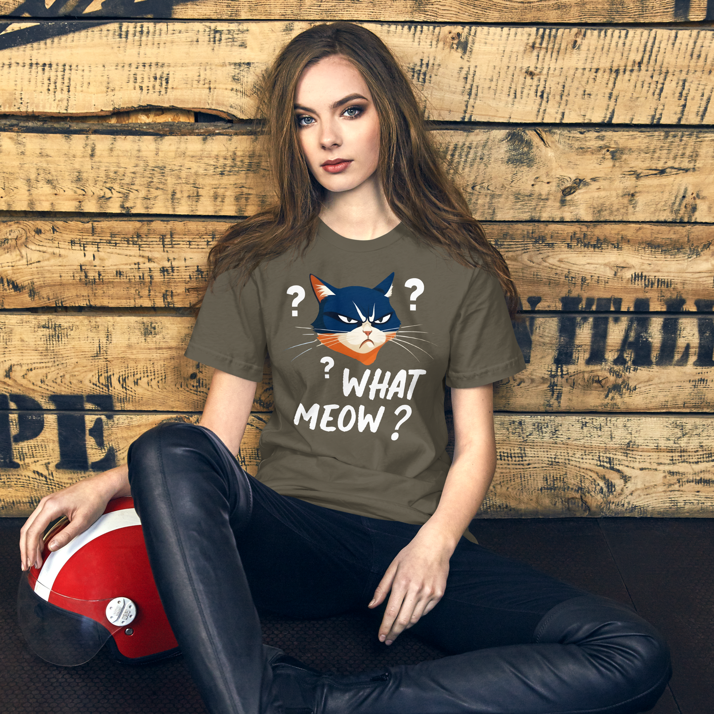 Woman wearing a t-shirt with a cat graphic and text, sitting against a wooden wall. - army