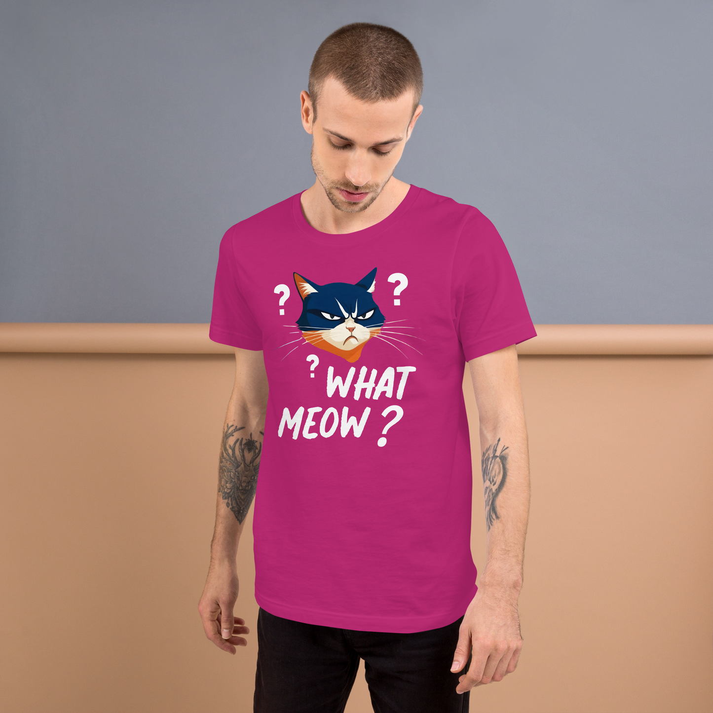 Man wearing a pink t-shirt with a cat graphic and text, standing against a plain background - berry