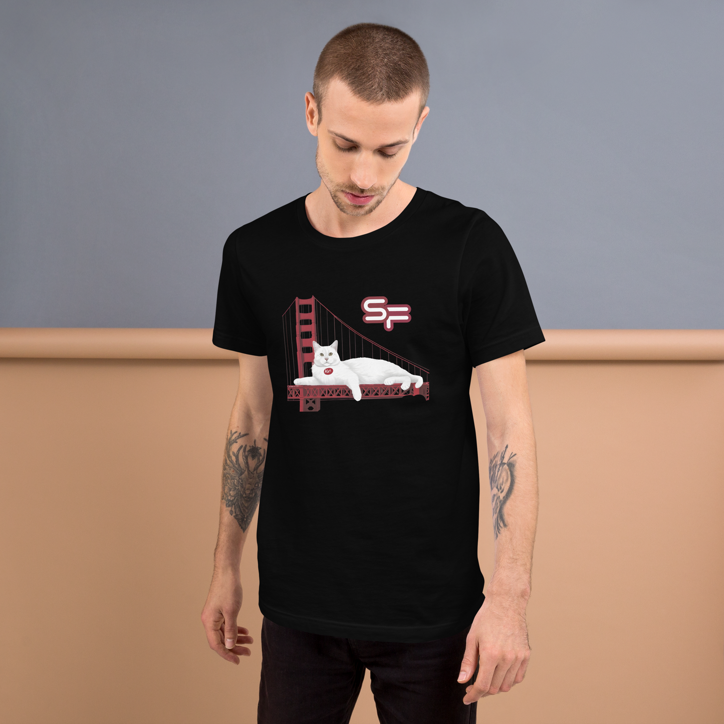 Man wearing a black t-shirt with a graphic design of a bear on a bridge, standing against a plain background. - black