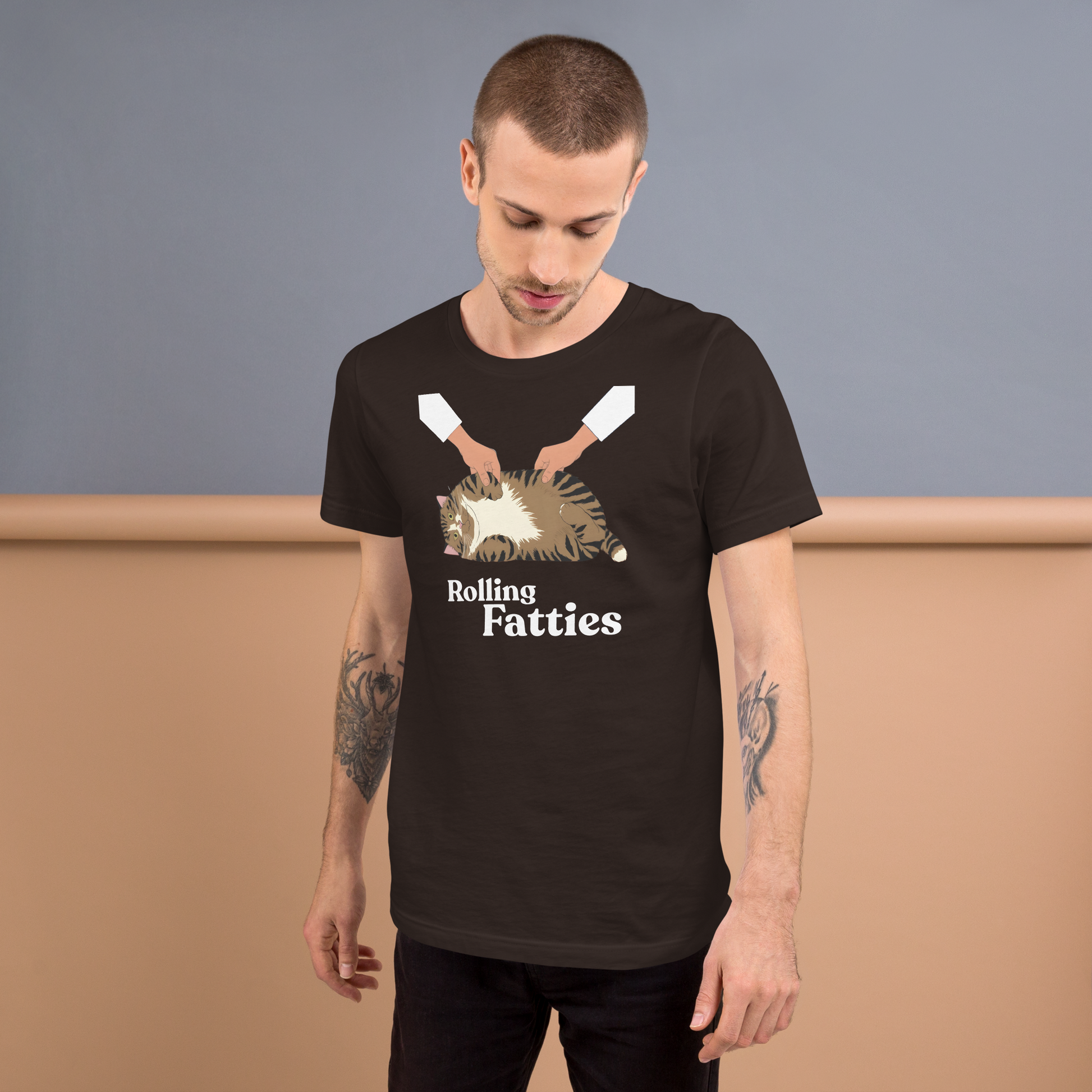 Man wearing a black t-shirt with 'Rolling Fatties' graphic design against a plain background - brown