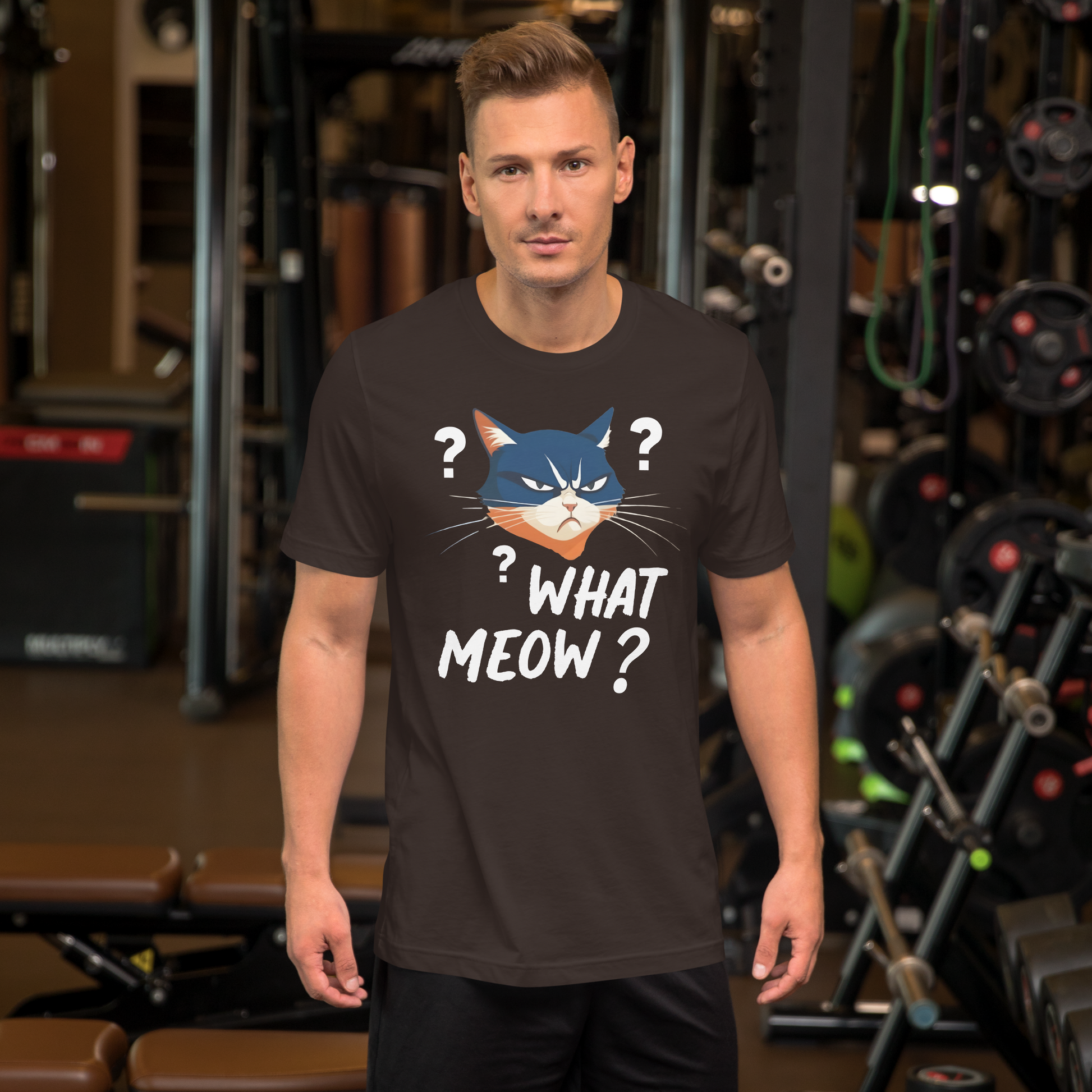 Man wearing a t-shirt with a cat graphic and text in a gym setting - brown