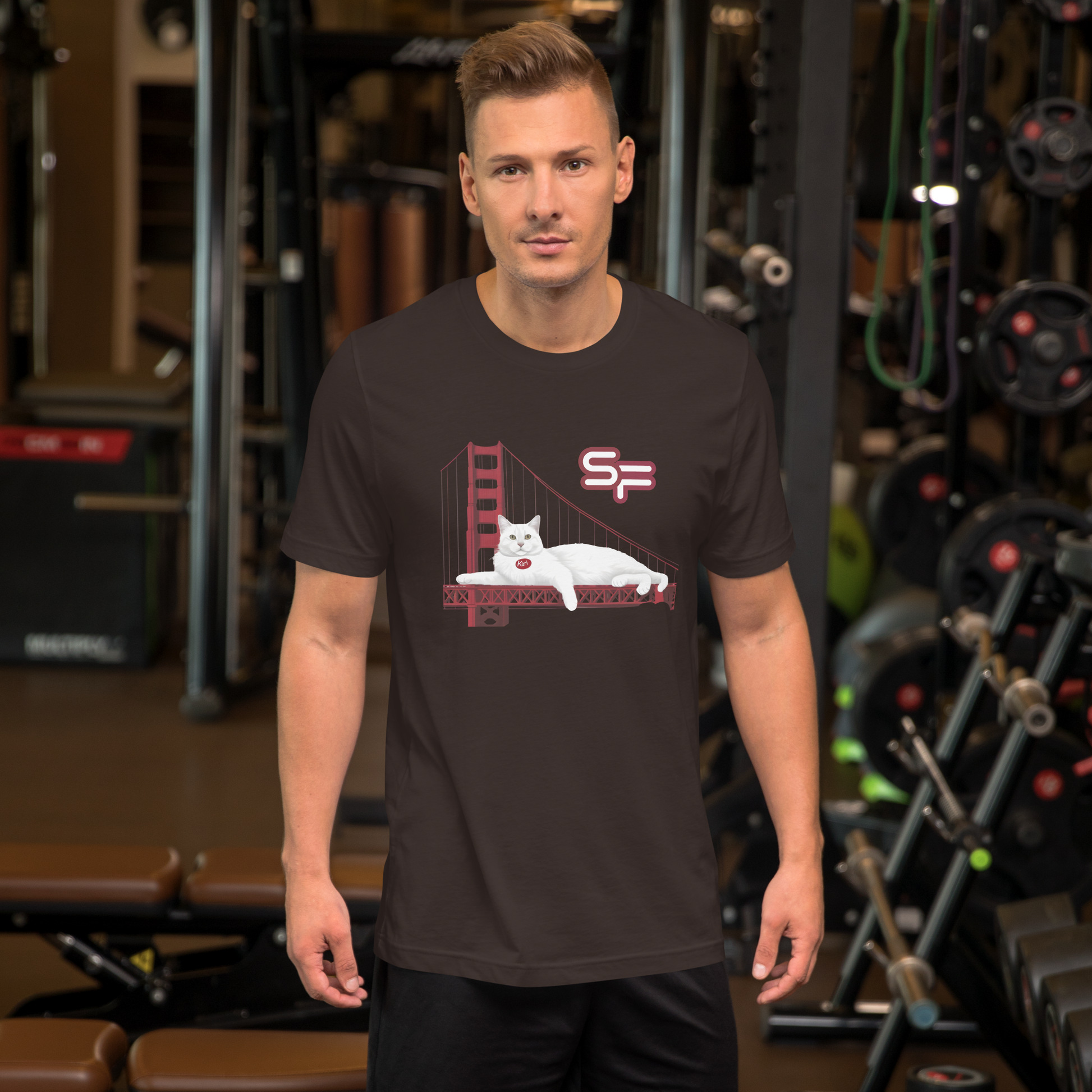 Man wearing a black t-shirt with a graphic design in a gym setting - brown