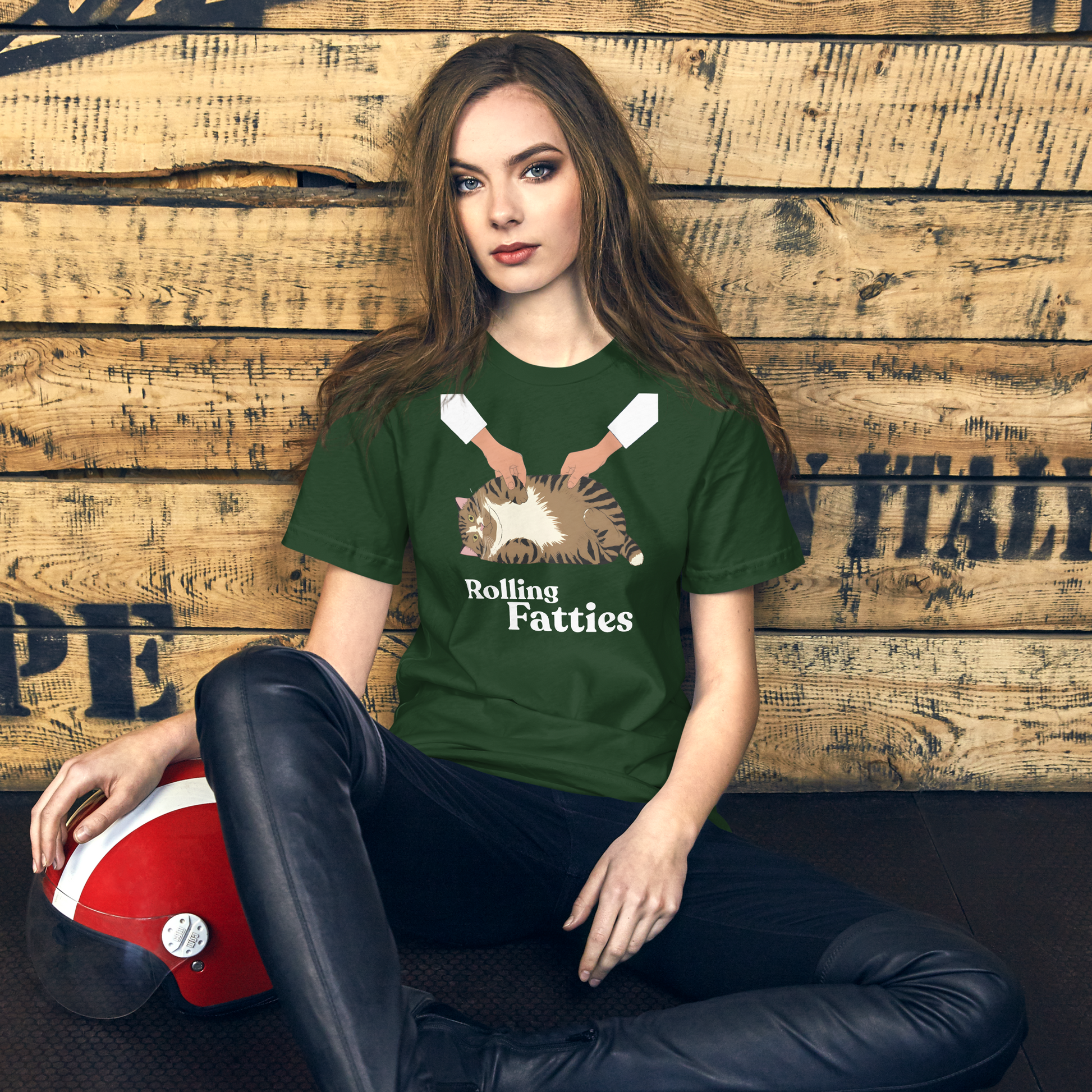 Woman wearing a green t-shirt with 'Rolling Fatties' design against a wooden wall. - forest