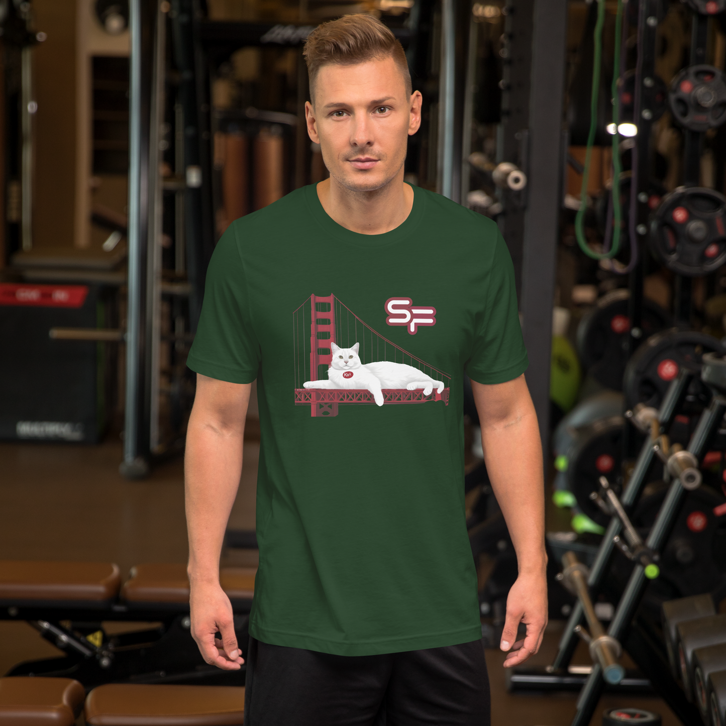 Man wearing a green t-shirt with a graphic design in a gym setting - forest