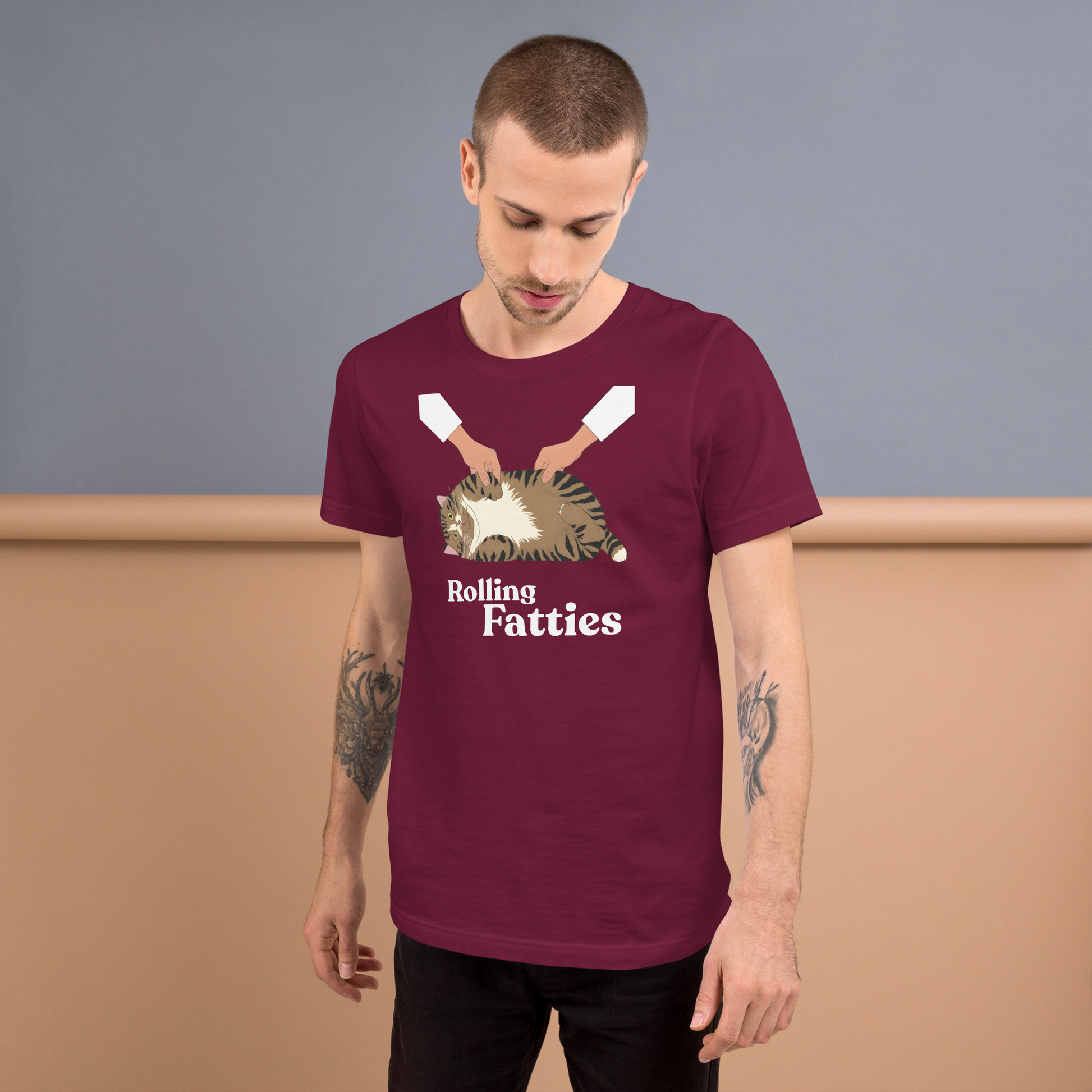 Man wearing a maroon t-shirt with 'Rolling Fatties' graphic design against a plain background - maroon