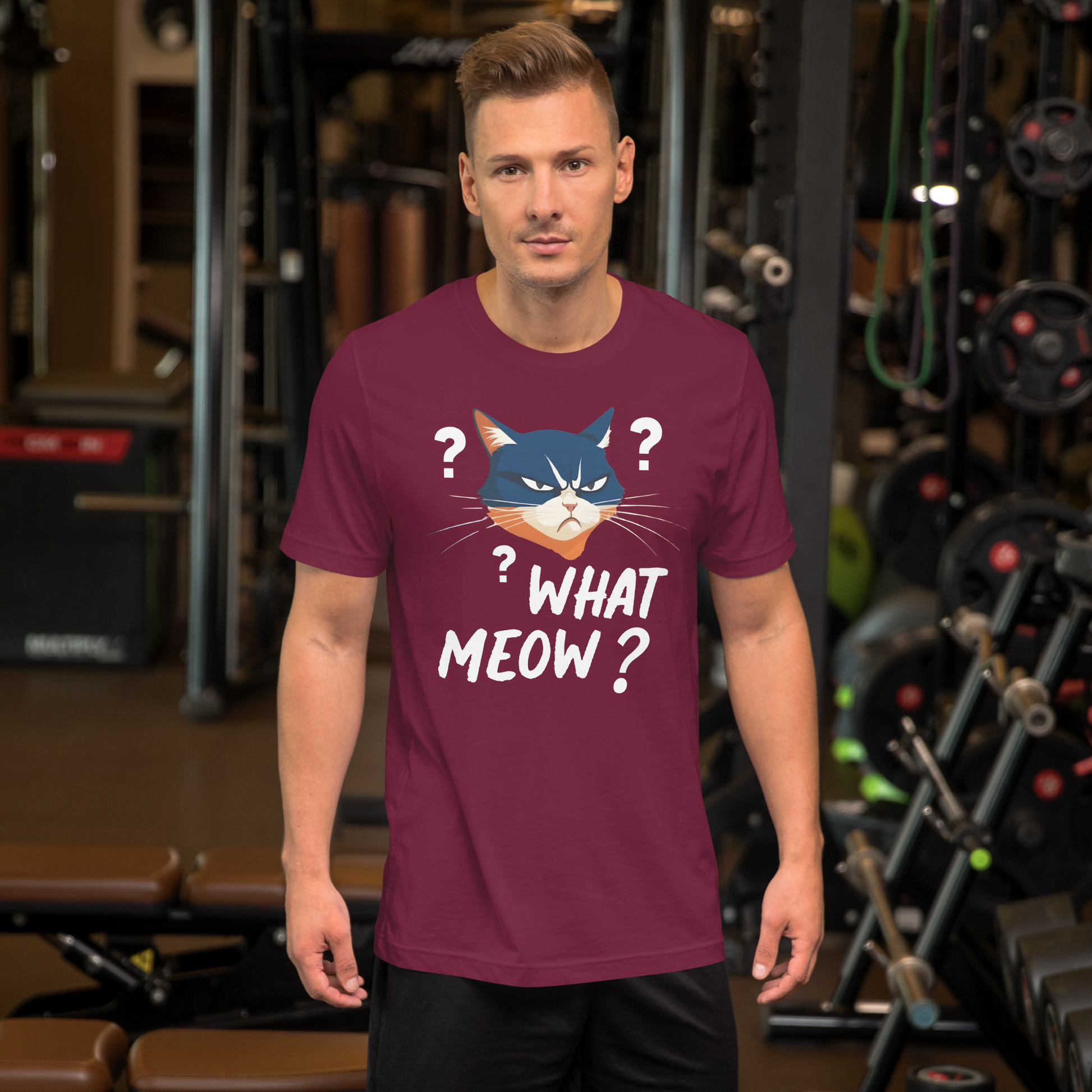 Man wearing a purple t-shirt with a cat graphic and text in a gym setting - maroon