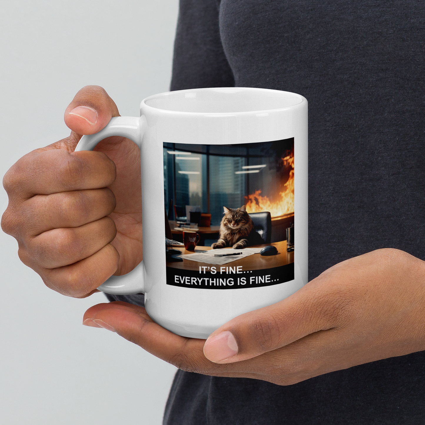 Person holding a white mug with a cat in an office fire scenario and text 'It's fine... Everything is fine...' - 15 oz