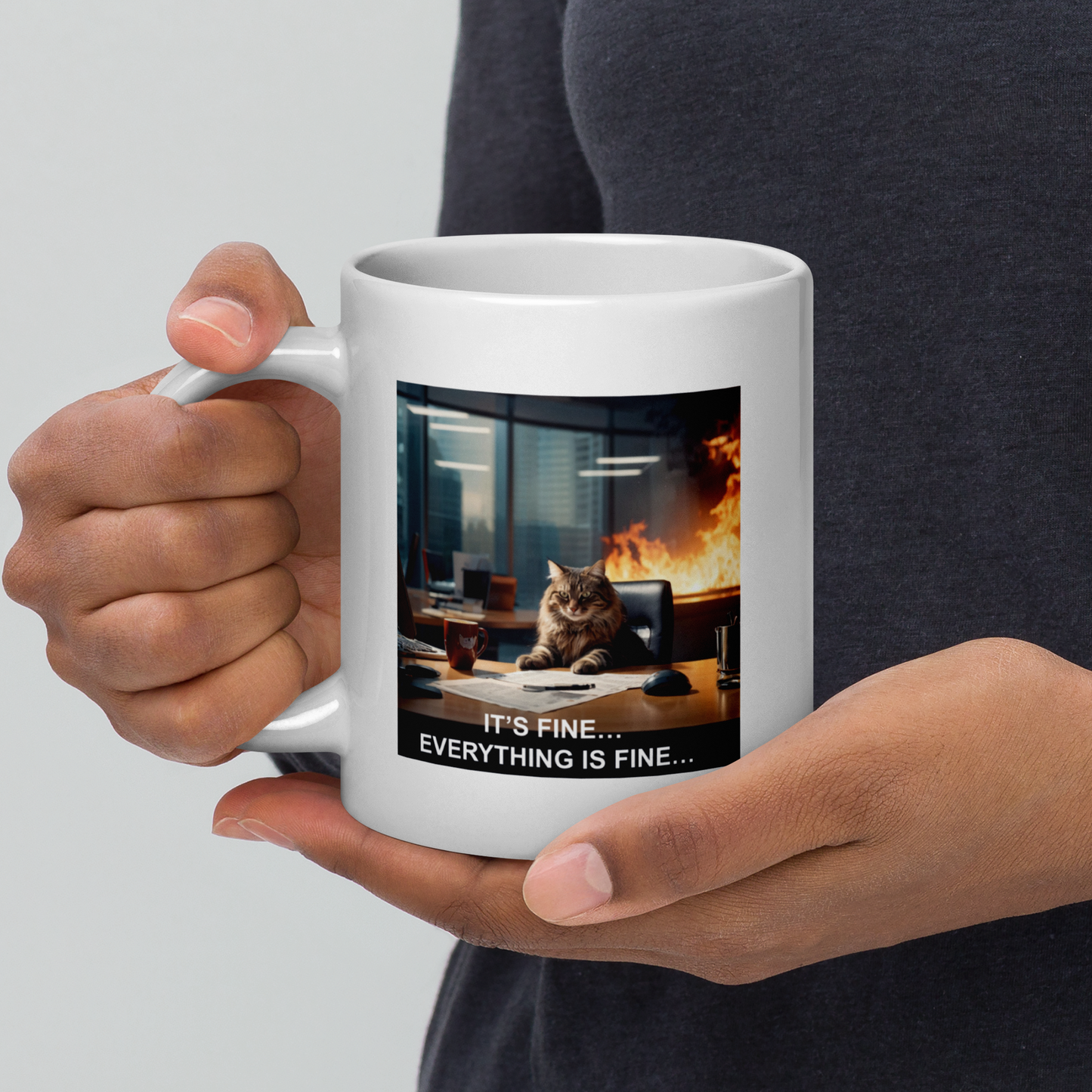 Person holding a white mug with a cat graphic and text 'It's fine... Everything is fine...' on a gray background - 20 oz