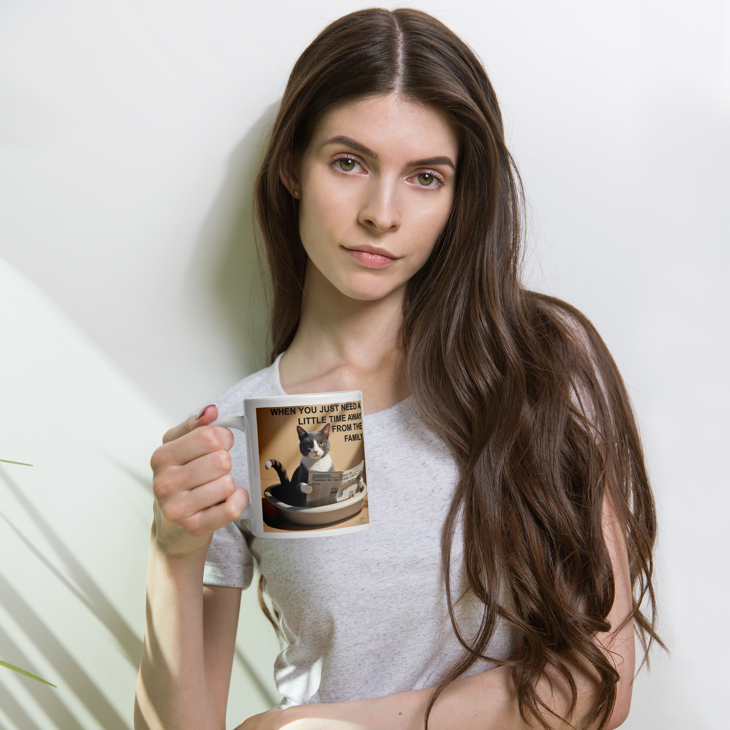 Woman holding a mug with a cat design and text on a light background - 20 oz